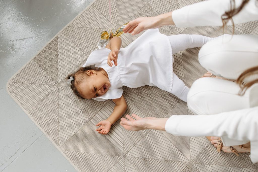high-angle-shot-of-a-baby-girl-crying-on-the-floor-7180270 High-Angle Shot of a Baby Girl Crying on the Floor